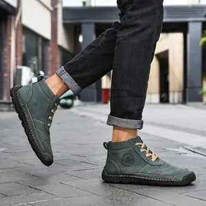 Side detail of men's high-top casual boots with handmade stitching and tan laces.