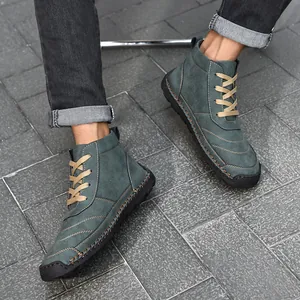 Detailed view of men's casual high-top teal leather boots with hand-stitched detailing