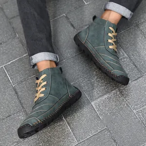 Detail of teal high-top men's Martin boots with handmade stitching and tan laces