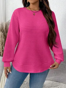 Detail of women's vibrant pink quilted grid pullover sweatshirt with waffle texture