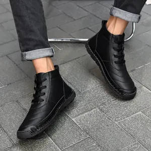 Close-up of black men's high-top leather Martin boots with handmade stitching details