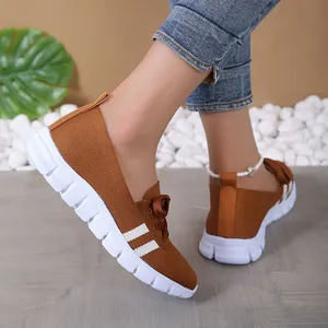 Detail view of brown breathable fly-knit casual shoes for women featuring white sole