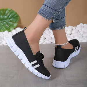 Side view of women's black flying knit casual shoes featuring thick white soles and striped details.