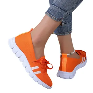 Breathable orange flying knit women's casual sneakers with stylish white stripe design