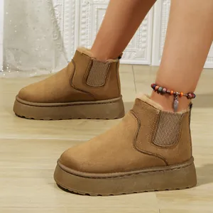 Detail view of stylish tan suede platform snow boots with warm faux fur lining