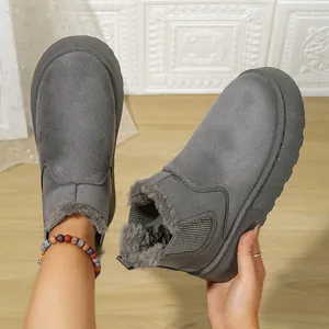 Close-up of grey plush-lined snow boots showing warm fur interior and suede texture