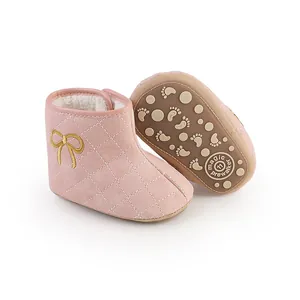 Detailansicht der gesteppten rosa Baby-Winterstiefel mit goldener Schleife und weicher Sohle