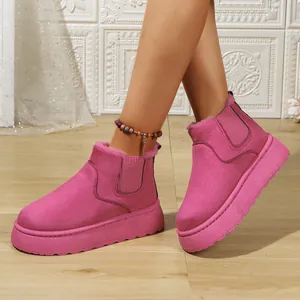 Detailed view of pink platform snow boots with plush lining and elastic side.