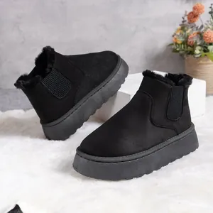 Close-up of black platform snow boots with warm faux fur lining for winter