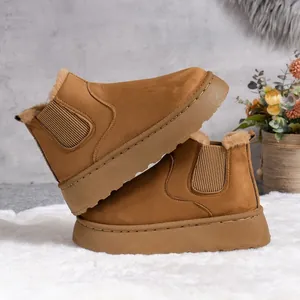 Detailed view of brown platform snow boots with warm faux fur lining on a rug
