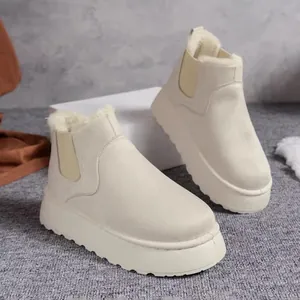 Detailed view of stylish beige women's platform snow boots with thick faux fur lining.