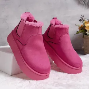 Close-up of pink fur-lined snow boots with thick platform soles for winter