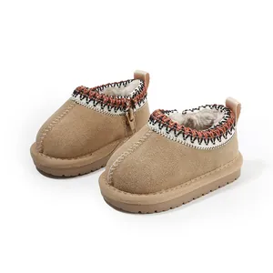 Warm and cozy tan baby snow boots with faux fur lining and ethnic woven trim detail