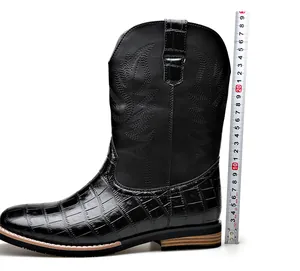 Close-up of black western cowboy boot shaft showing 25cm height measurement detail