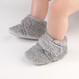 Detail of grey fleece-lined baby walking shoes with soft sole and hook-and-loop closure