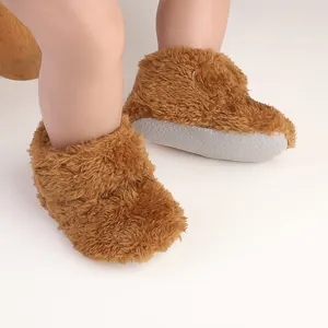Close-up of fuzzy baby winter shoes with soft non-slip sole and warm plush brown texture