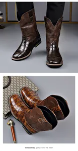Detail view of men's vintage western cowboy boots with embroidery and crocodile pattern