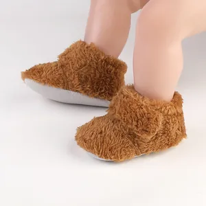 Detailed view of brown fluffy baby winter walking shoes with soft non-slip soles