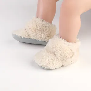 Detailed view of fluffy cream-colored baby walking shoes with soft anti-slip soles