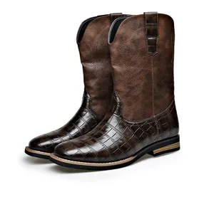 Vintage brown leather western cowboy boots featuring unique crocodile embossed pattern.
