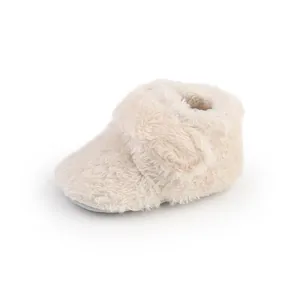 Detail view of soft plush winter baby booties featuring cozy faux fur and velcro strap