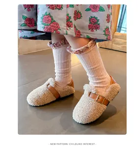 Close-up detail of children's cozy wool fleece shoes with elegant leather buckle strap