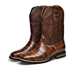 Detailed view of men's vintage brown western boots with crocodile texture and embroidery