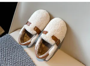 Detailed view of cozy white curly fleece texture on children's winter shoes with buckles