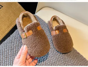 Detailed view of children's warm brown fleece wool slippers featuring decorative buckle