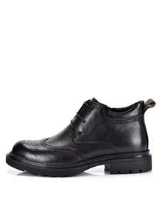 Side view of black leather wingtip brogue boots for men with durable lug sole