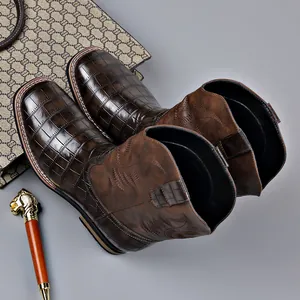 Vintage brown men's western cowboy boots featuring embroidery and faux crocodile texture