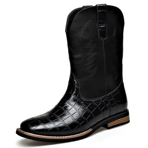 Retro western cowboy boots for men with embroidery and crocodile texture on white background