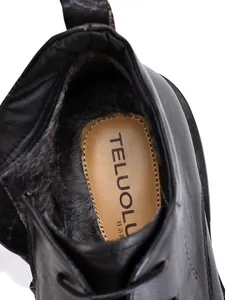 Detailed macro view of black leather Martin boot interior featuring warm faux fur lining