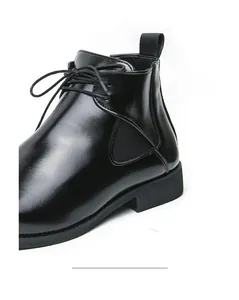 Close-up of black men's leather Chelsea boot with sleek finish and elegant lace-up detail