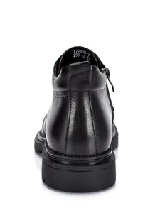 Detailed rear view of black leather Martin boots showing heel and sole texture.