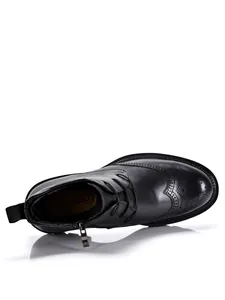 Detailed top view of black cowhide leather Martin boots with brogue wingtip pattern