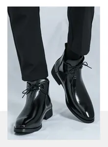 Detail of black glossy leather Chelsea boots for men in a stylish British aesthetic
