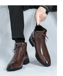 Detail view of stylish brown glossy leather Chelsea boots for men in British style