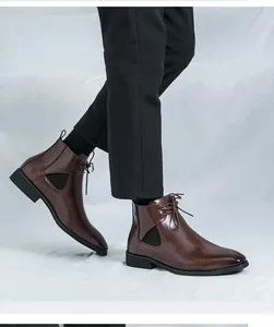 Side view of professional brown leather Chelsea boots with laces worn by a male model
