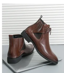 Detailed view of brown leather Chelsea boots for men with lace-up and zip details