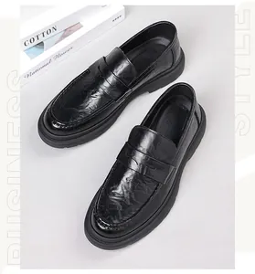 Macro view of black men's loafers showing hand-grabbed grain leather texture and thick sole