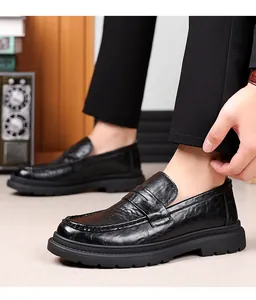 Detail shot of black crinkled leather men's business casual penny loafers on model