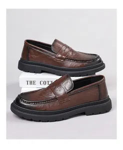 Detailed side view of premium brown hand-rubbed leather men's loafers with a thick black sole