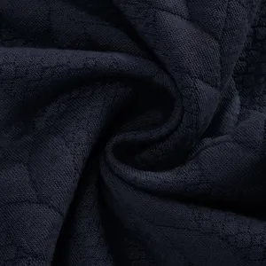 Detalle macro de tela de punto jacquard azul marino que muestra la textura y el tejido