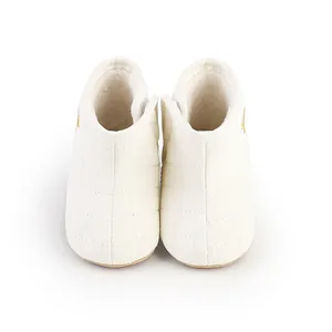 Detailed front view of white quilted winter baby boots with soft fleece lining for warmth
