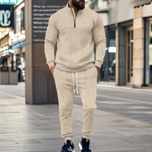 Stylish beige men's two-piece tracksuit set featuring jacquard texture and half-zip collar