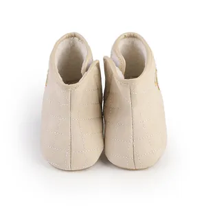 Cozy beige quilted baby boots with warm faux fur lining and velcro strap for infants
