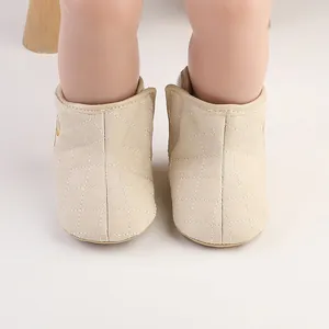 Front view of quilted beige baby winter boots with warm fleece lining interior