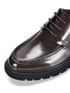 Close-up of glossy dark brown leather Derby shoes showing fine stitching details
