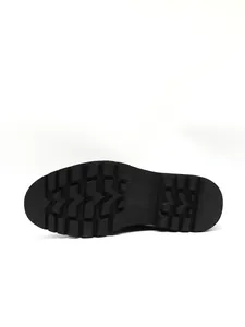 Detailed view of the durable rubber lug sole on black formal derby shoes.